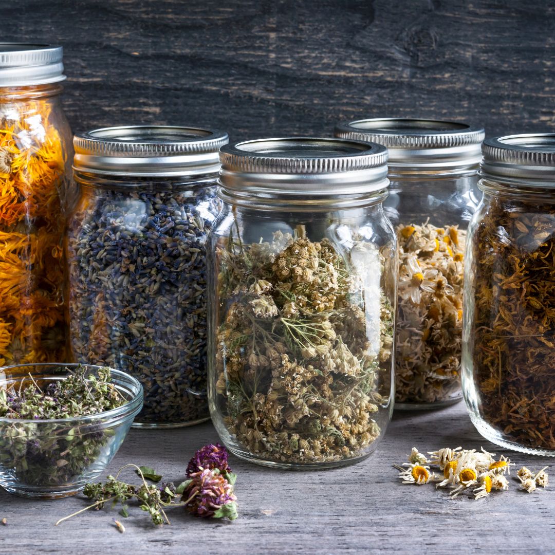 Multiple Clear Mason jars with Dry herbs inside