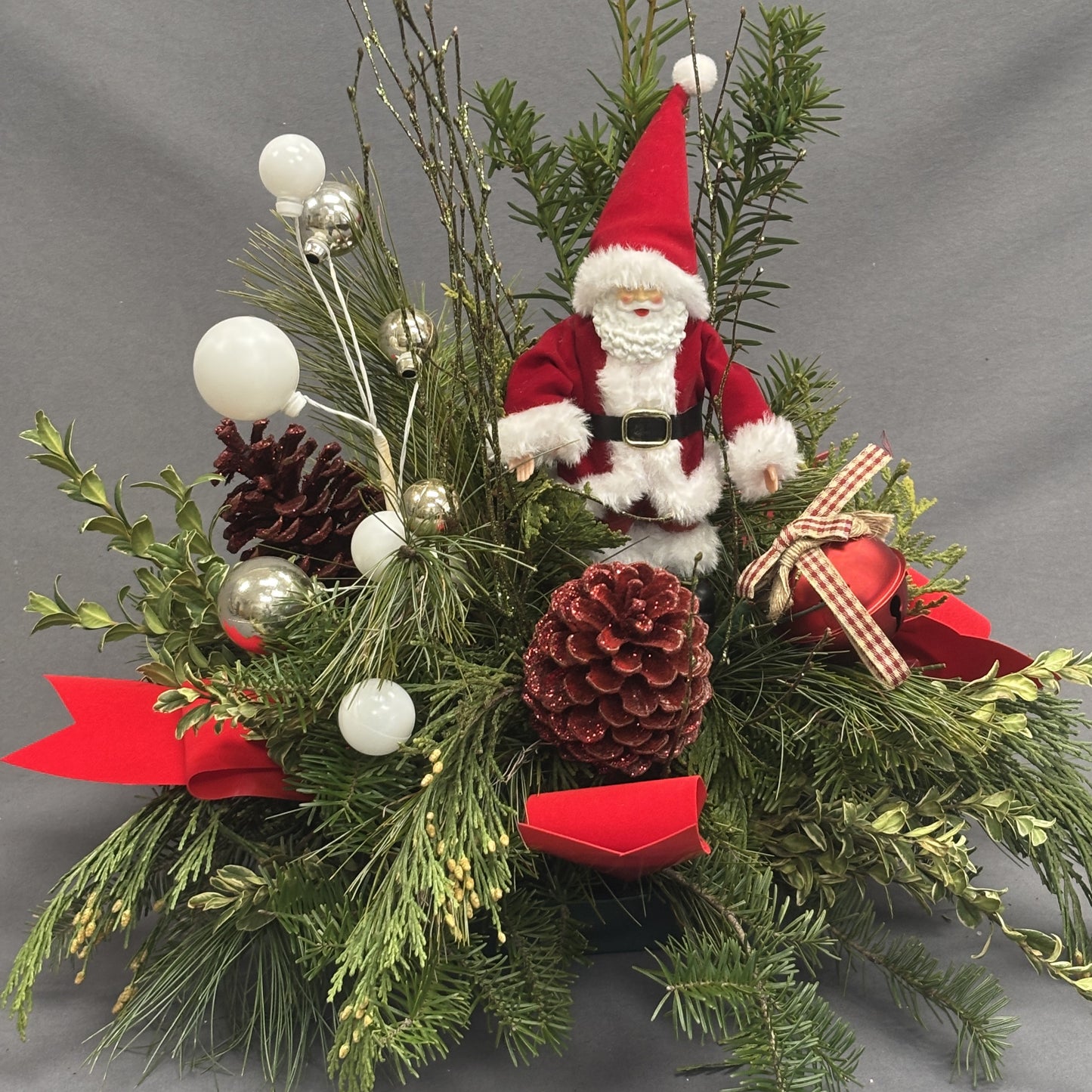 Fresh Greens Centrepiece with Santa and Red Cones